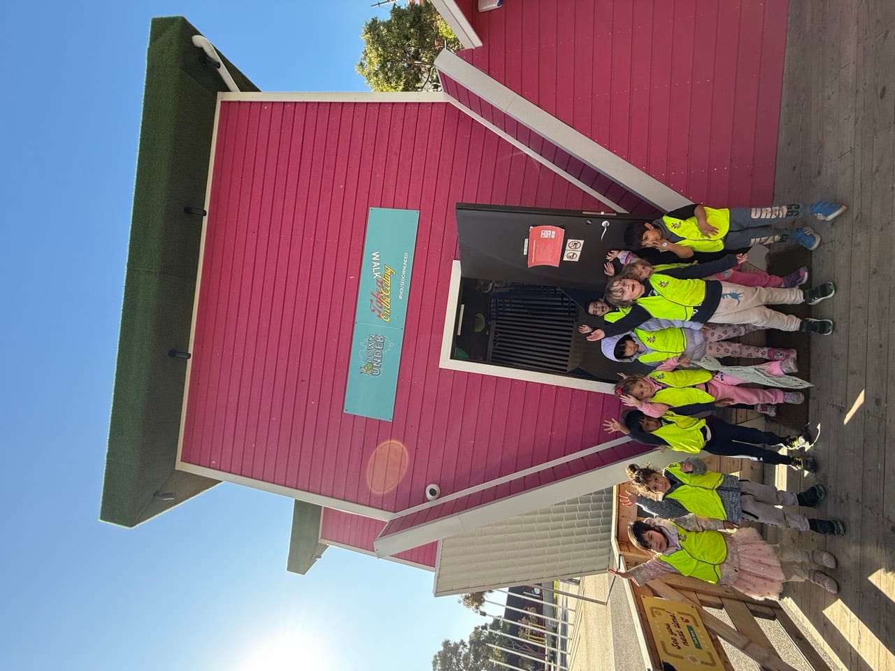 Children gathered outside the centre in high-visibility vests before an outing.