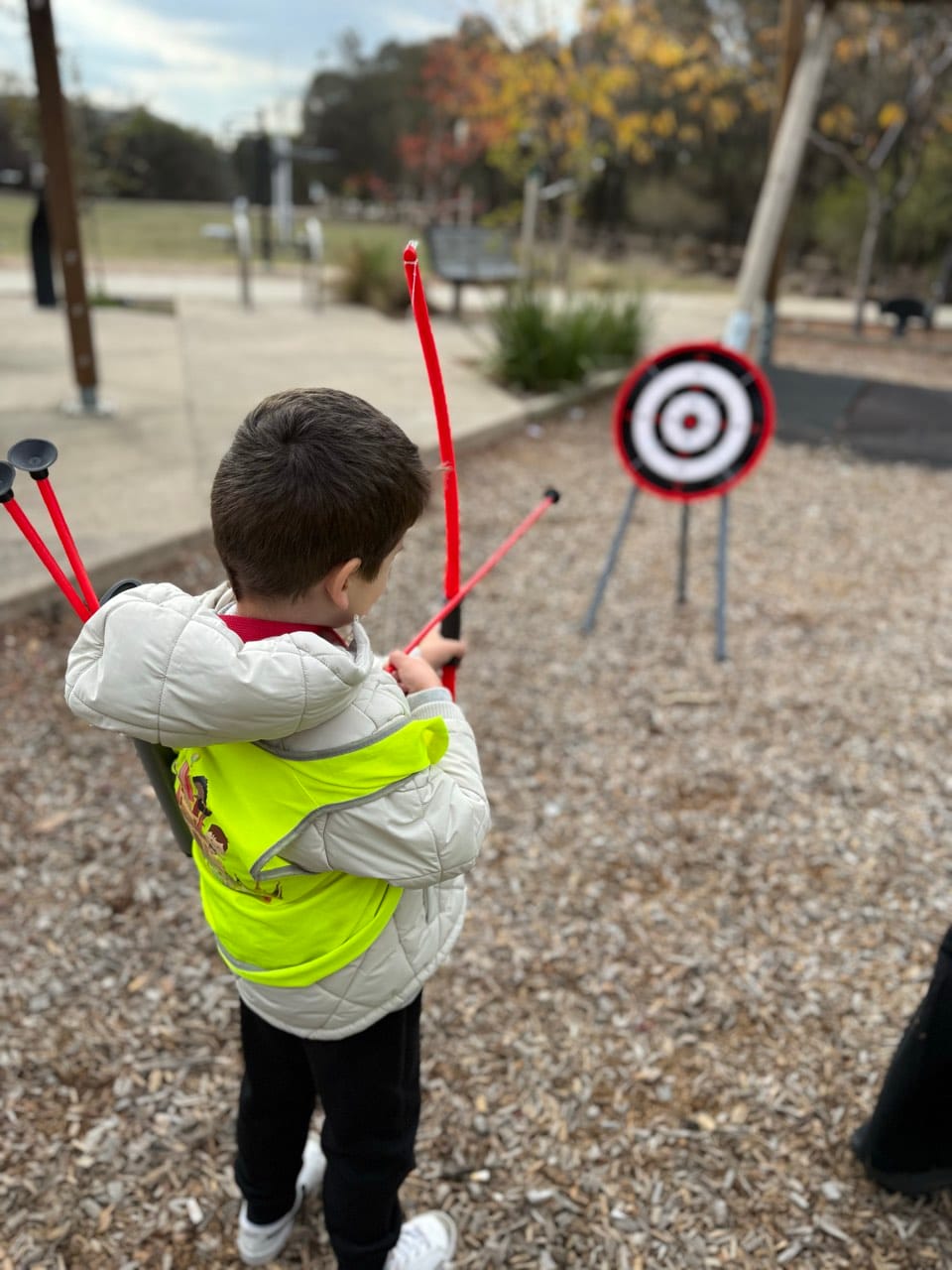 A child in a high-visibility vest taking part in a road safety excursion walk.
