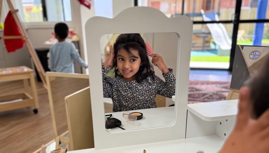 A child exploring a mirror play setup inside the Hoppers Crossing centre.