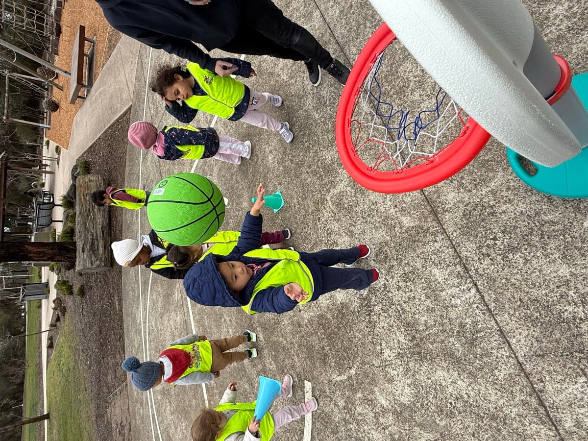 Children exploring together outdoors during a real Kids Kingdom group experience.